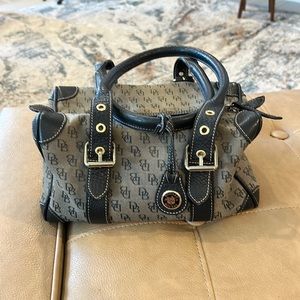 Vintage Dooney and Bourke handbag with black  trim on a gray bag signature